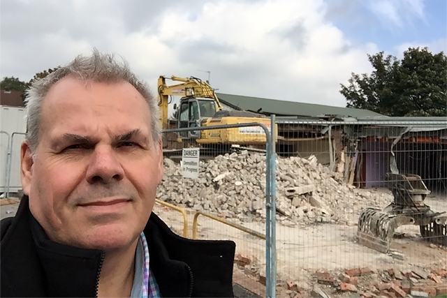 Councillor Richard Farnell watches as builders demolish Kirkholt Workingmen's Club