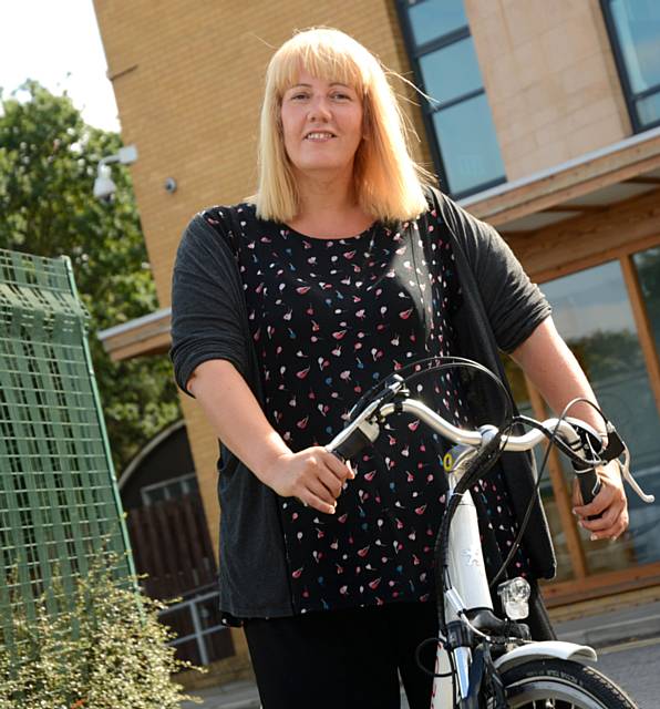 Sarah Riley, Community Development Coordinator at Great Places Housing Group using her eBike