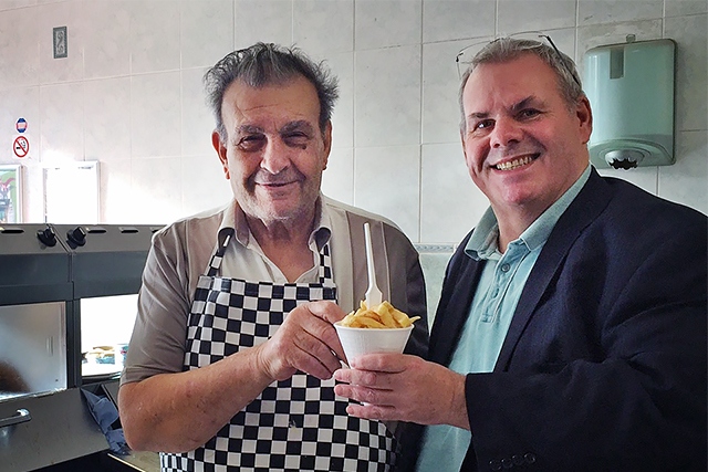 Ken Pashi serves up his last lot of chips to Councillor Richard Farnell before the big move