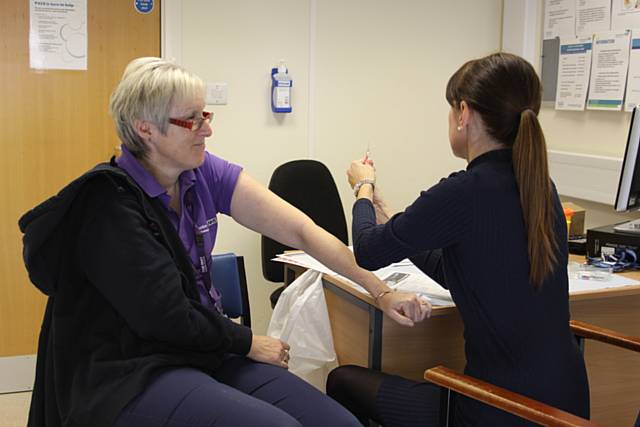 Julie Emerson Technical Instructor with the Children’s Occupational Therapy Team, receiving her flu vaccine