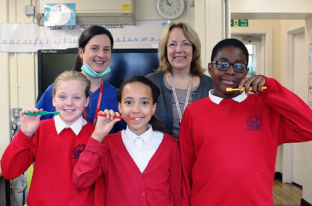 St Mary's year 6 pupils Grace Royal, Mischa Eaton & Edwin Otasowe with dentist Bernie Lackey (back left) & deputy headteacher Kay Whitfield (back right)