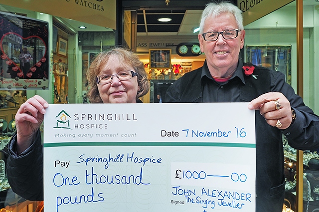 John Alexander presents a cheque for £1,000 to Springhill Hospice’s Barbara Lloyd