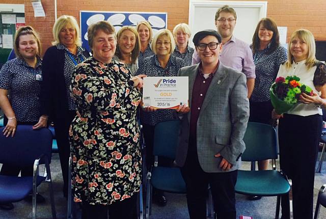 The Castleton GP Practice receive their Pride in Practice Gold Award, behind left to right:  Amber Clarke, Barbara Mitchell, Angela Cockcroft, Karen Pearson, Hilary Cardona, Debbie McMillan, Dr Edwards, Marie Chadderton and Jane Gaunt. Accepting the award is Dr Schofield (front left) from Pride In Practice Manager, Laurence Webb