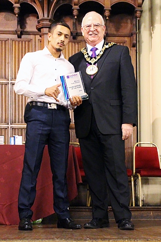 Farmanullah Nawrozy is presented with his award by Mayor Ray Dutton