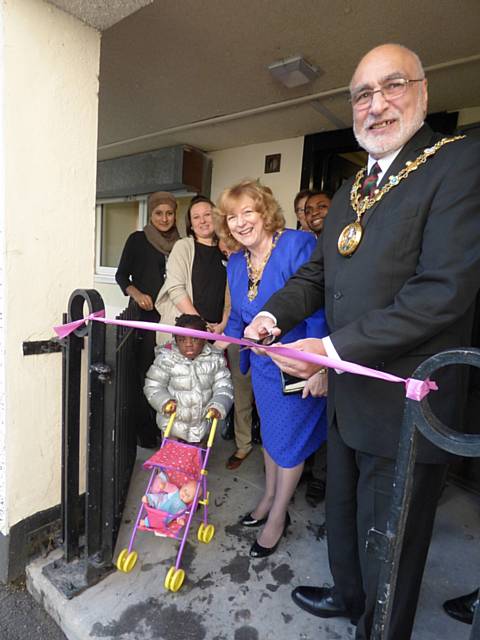 Mayor Surinder Biant cuts the ribbon to open the café, joined by Mayoress Cecile Biant, staff, volunteers and families