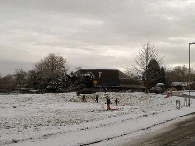 Heritage Green, young toddlers sledging down the gentle slopes, mass snow ball fights and family teams building giant snowmen 