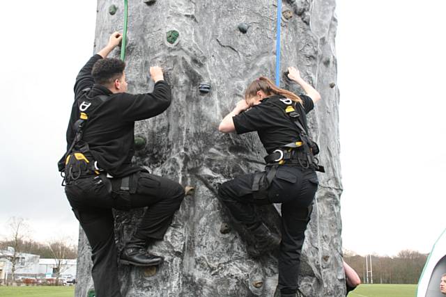 Romon Francis and Natasha Hopkins climb the 8m high mobile climbing wall - the largest in the country