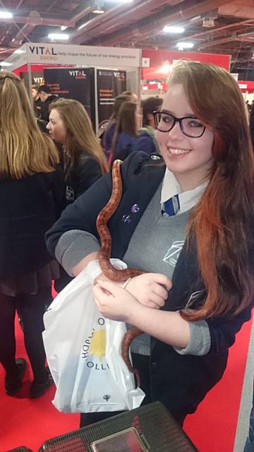 A happy visitor gets to handle a snake