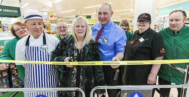 Rochdale Morrisons loyal shopper Jackie Hirst cuts the ribbon with store manager Peter Matthews and staff