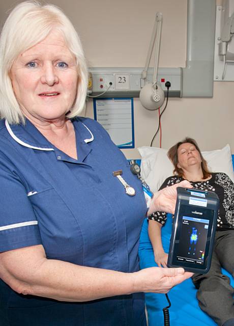 Pauline Abraham, Ward Manager at The Royal Oldham Hospital with the new bedside pressure monitoring device 