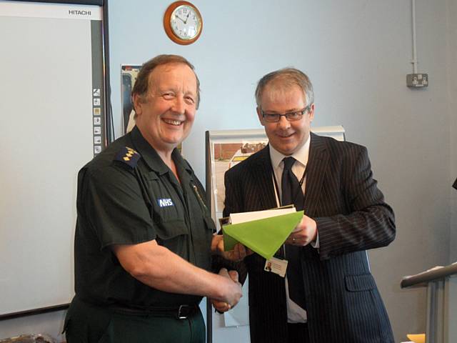 Steve Evans at the retirement presentation with NWAS Head of Driving Standards Paul Jones-Roberts