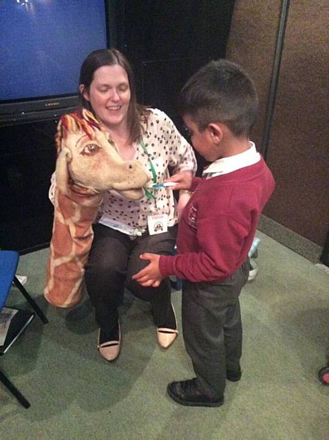 Kentmere Academy pupil learns to clean a Harold the Giraffes teeth 