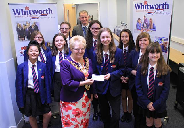 Retiring Mayor of Whitworth Councillor Lynda Barnes presents Ambassador Katie Bray with a cheque for £200 to help towards training with other ambassadors and Assistant Headteacher Paul Dugdale