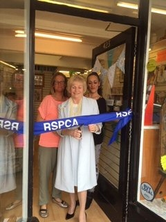 RSPCA volunteer Marlene Oliver cutting the ribbon of the new shop