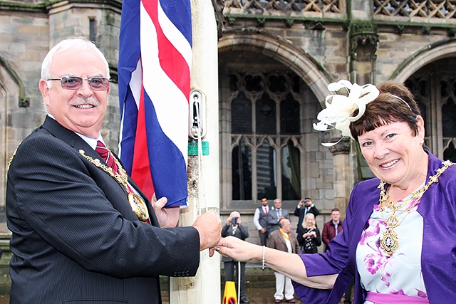 Celebration for the Queen’s 90th birthday at Rochdale Town Hall<br /> Mayor Ray Dutton and Mayoress Elaine Dutton raise the Union flag