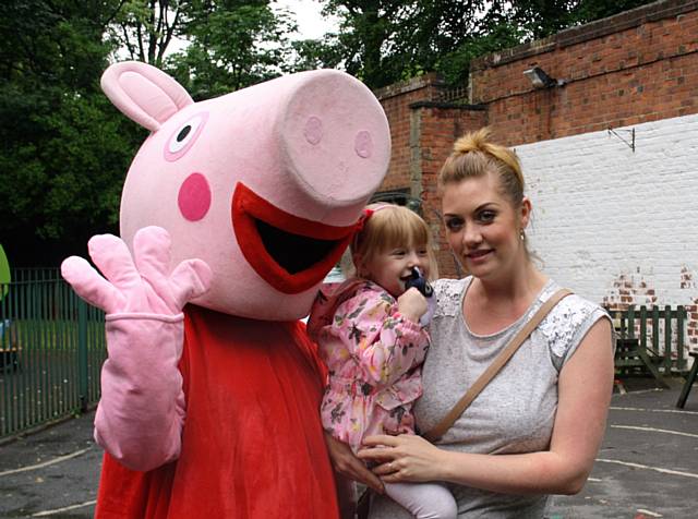 Suzi Burgess and her daughter Daisy with Peppa Pig at The School House Nursery Summer Fair 