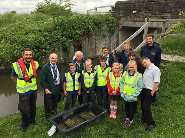 Councillor Billy Sheerin with children from St Edwards Church of England Primary School and volunteers from the Canal & River Trust at Rochdale Canal