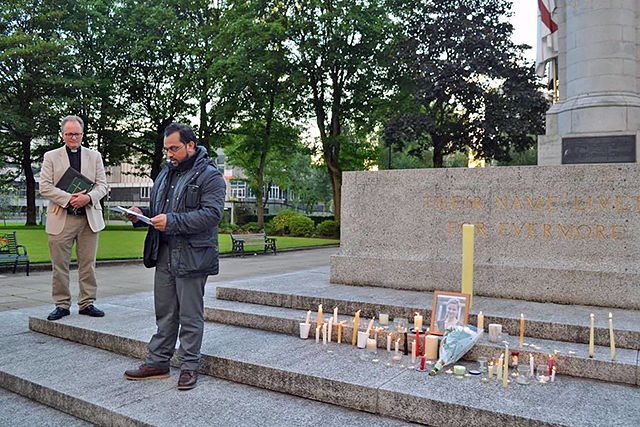 Dobir Miah, from Rochdale Council of Mosques, speaking at the vigil for Jo Cox watched by the Vicar of Rochdale, Reverend Mark Coleman