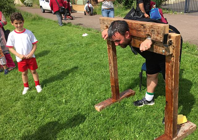 Beech House Summer Fair - sponging Mr Howard, the assistant head teacher, in the stocks