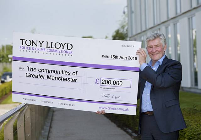 Tony Lloyd presenting big cheque to communities of Greater Manchester