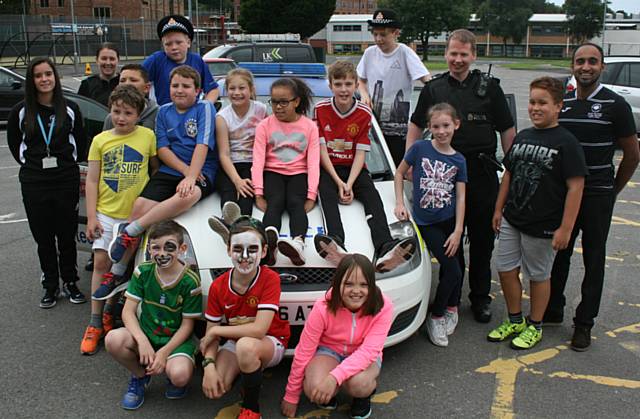 Children with Inspector Kris Williams and PC Tracey Lowe and Hopwood Hall College staff, Holly Espie (far left) and Dewan Choudhury (far right)