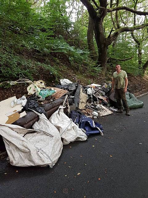 Paul Ellison with the flytipping rubbish from Ashworth Valley