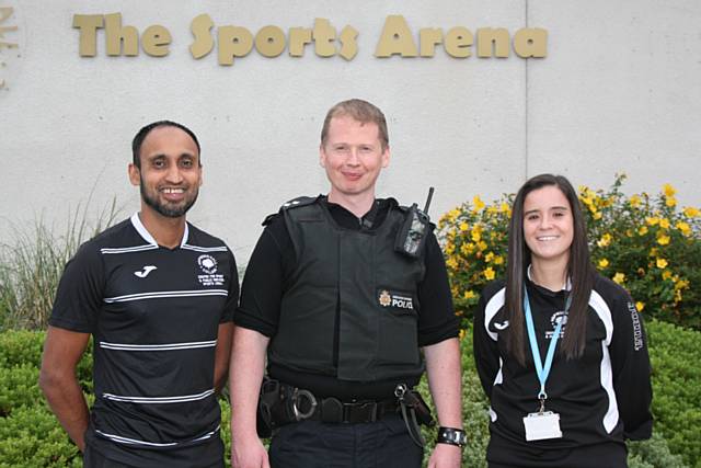 Hopwood Hall College’s Football Development Officers Dewan Choudhury and Holly Espie with Inspector Kris Williams