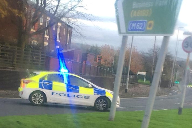 A police car blocks access to Albert Royds Street from the roundabout