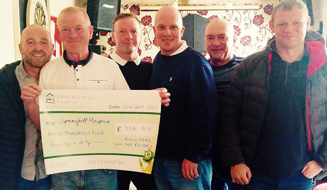 Landlord Paul Quinn holding the cheque, and Bulls Head regulars