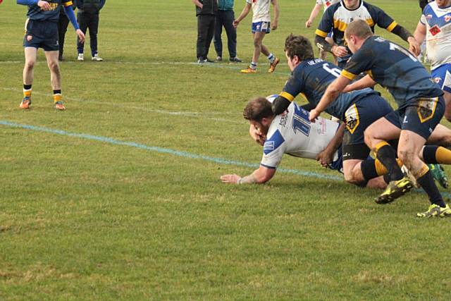 Aiden Gleeson crashing over to score