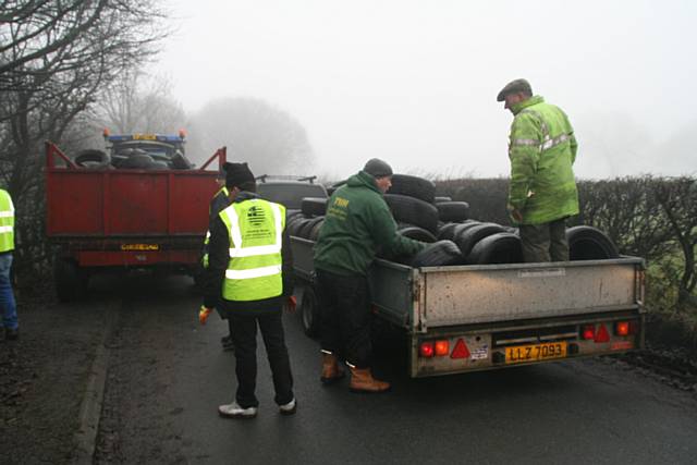 80 volunteers retrieve 700 tyres up a steep embankment to Ashworth Road 