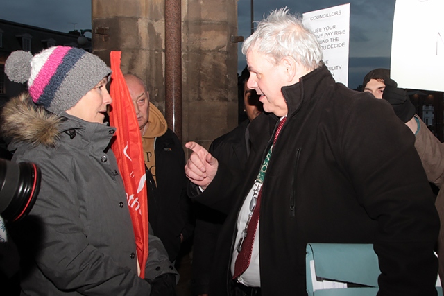 Protesters tackle Leader of the Council Richard Farnell about the massive increase in councllors' allowances on his way into the Council Budget Fixing meeting