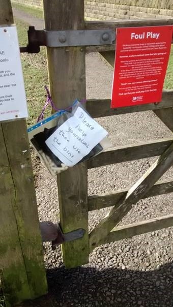 Free dog poo bags with a note offering people to take and use them to keep the place clean and tidy