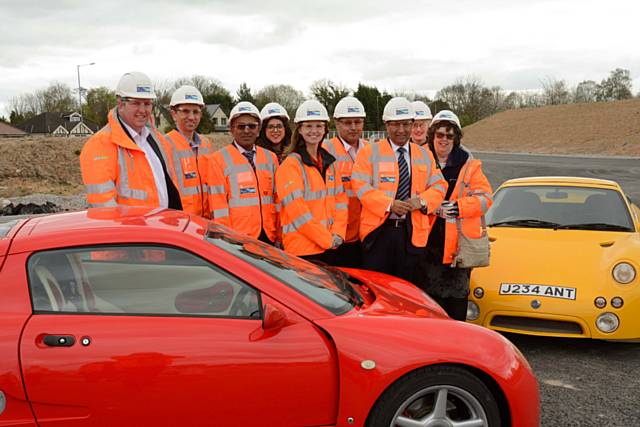 Members of the project synergy team with two autonomous concept vehicles