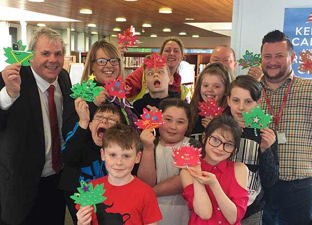 Councillor Richard Farnell (left) and Garry Johnson, head of St Mary's Primary School (right) with youngsters and helpers enjoy an enviro-day at Balderstone Park