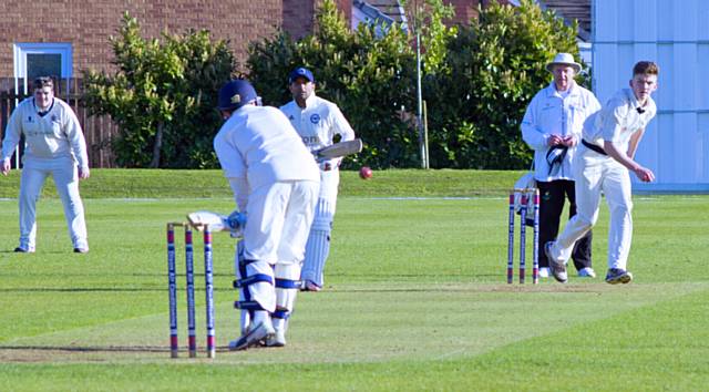 Young Thornham bowler R Baxter attempts to dislodge the Westhoughton middle order