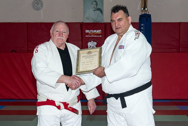 Warren Schofield presented his Seventh Dan certificate by Simon Smith