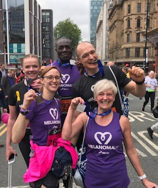 Gary (top right) with gym members show off their Great Manchester Run medals