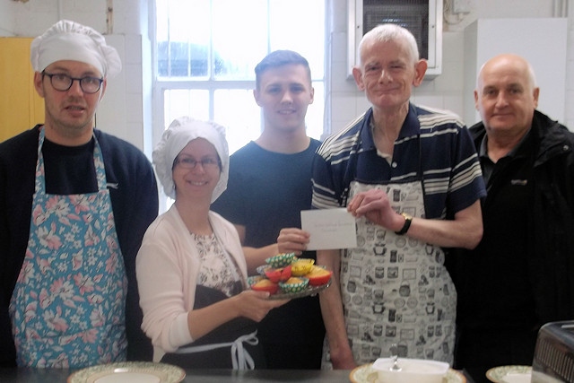 Brad Gartland (centre) and Pete Duffy (far right) from the SG6 Foundation presenting a cheque to participants of Kitchen Kapers