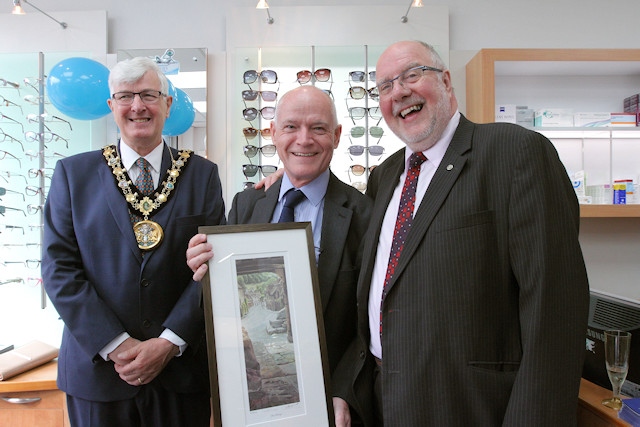 Paul Cheetham with a gift, a Geoff Butterworth painting, from John Kay (right)