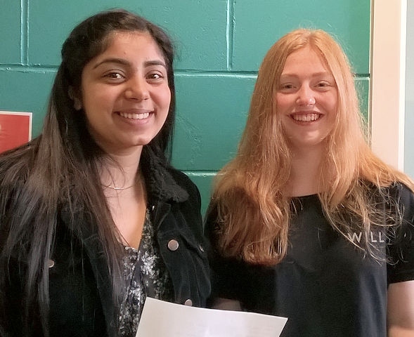 Zoya Gill and Lucy Crabtree with their exam results from Oulder Hill Community School and Language College