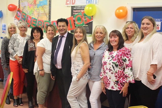 Councillor Iftikhar Ahmed, with members of staff who help deliver the award winning service