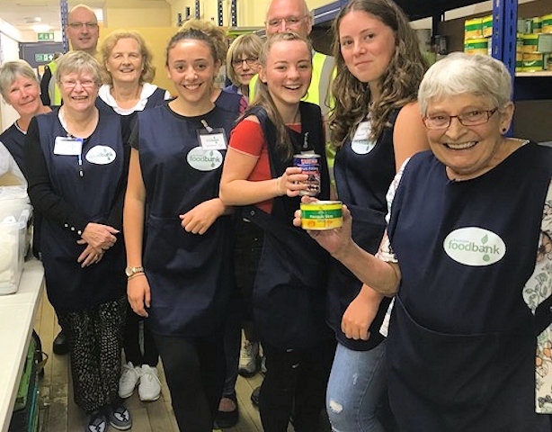 Ellie Jenkinson, Amy Hanson and Rebecca Burnett  with members of the Friday team at Rochdale Foodbank