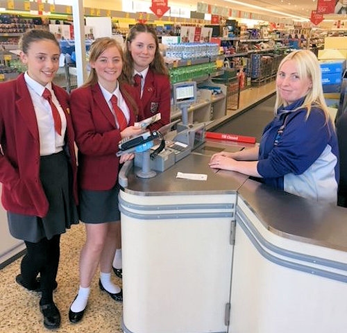 Ellie Jenkinson, Amy Hanson and Rebecca Burnett buying food for Rochdale Foodbank