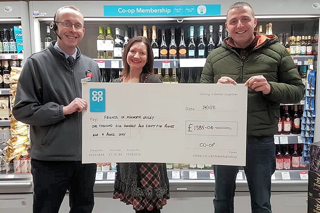 Carl England from the Co-op presents the cheque to Zoe Hotchkiss and Paul Ellison from Friends of Ashworth Valley