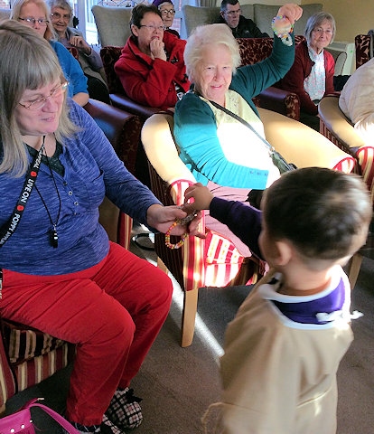 children giving out their presents to the residents 