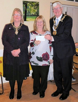 Ellen Wintle-Yates, Chair of Heywood in Bloom, accepts a cheque from the Mayor and Mayoress