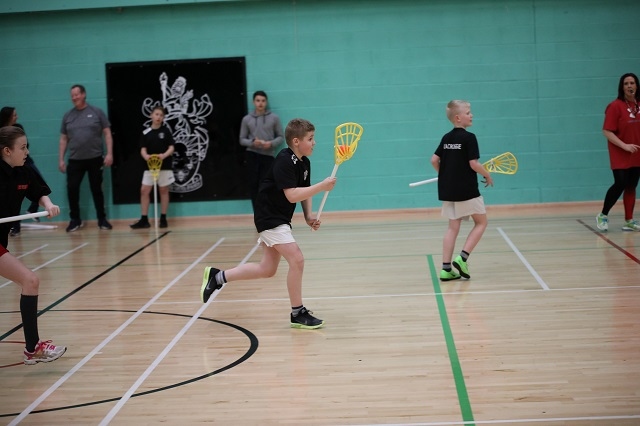 Pupils from St James Primary playing pop lacrosse