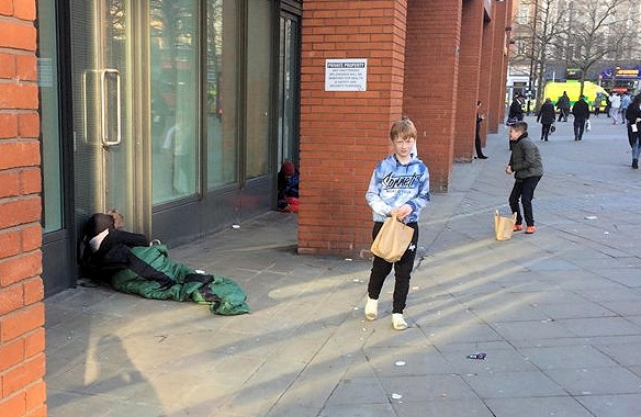 Milnrow Cricket Club juniors distributed food to the homeless in Manchester, seen here in Piccadilly 