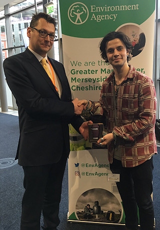 Environment Agency Area director for Greater Manchester, Merseyside and Cheshire Lee Rawlinson, presenting Cold Feet actor and BBC R1 DJ Ceallach Spellman with his very own reusable cup